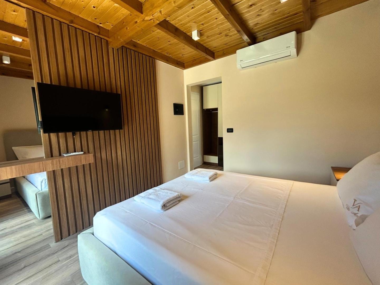 Warm cove lighting along a timber-plank ceiling